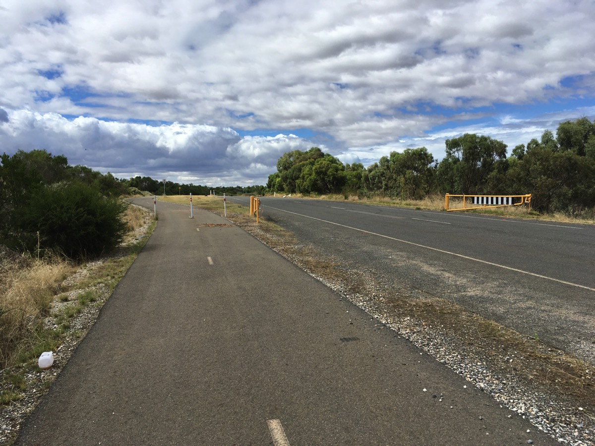 The road is on a floodway so it has gates and the path bollards